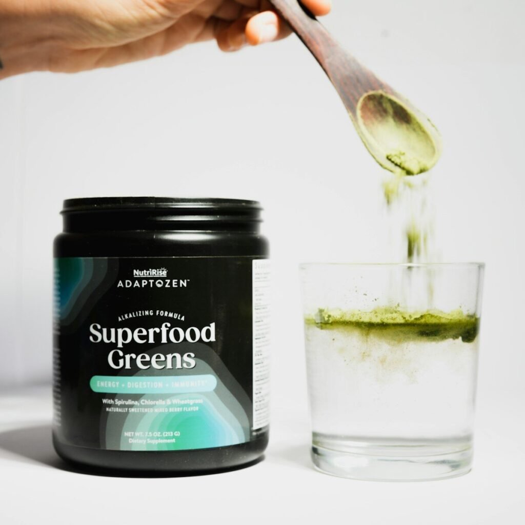 Superfood greens powder being poured into water
